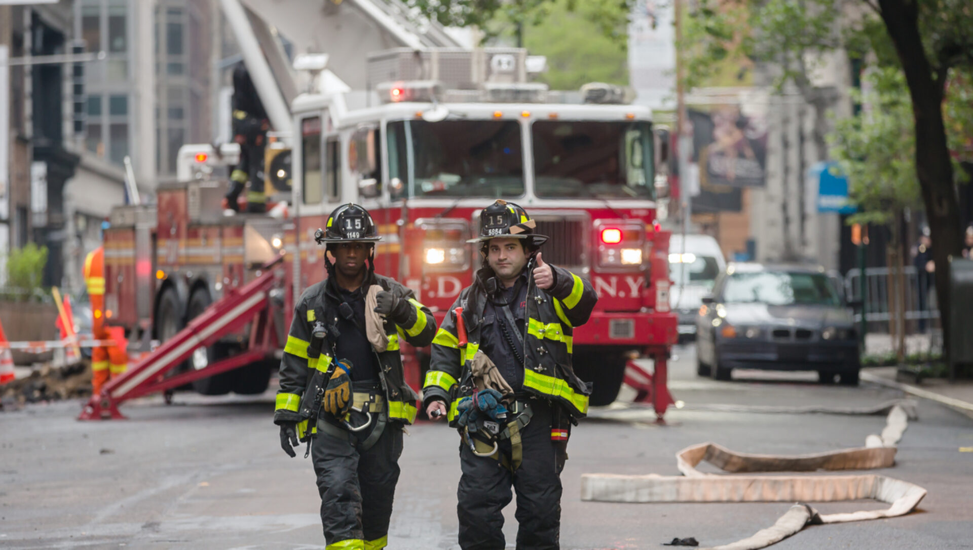 NYC firefighters give a thumbs-up sign.